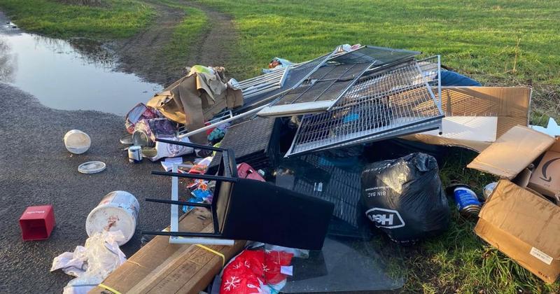 Giant mound of dumped items and glass spread across road in Norfolk village